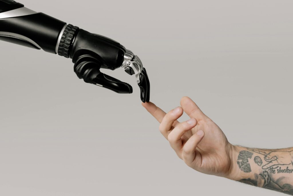 Robot arm and a human hand touching finger tips